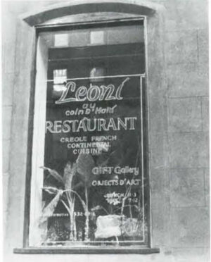 Leoni Au Coin D’Haiti Restaurant. Name of restaurant stenciled on windowpane