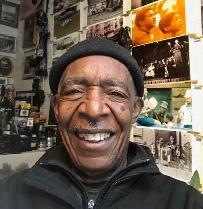 Alex Harsley may 2020 standing in his studio smiling