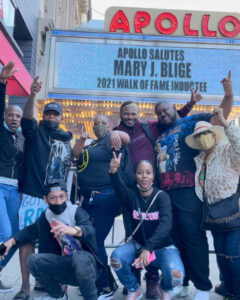 Fans point to the Apollo Marquee with Mary J. Blige