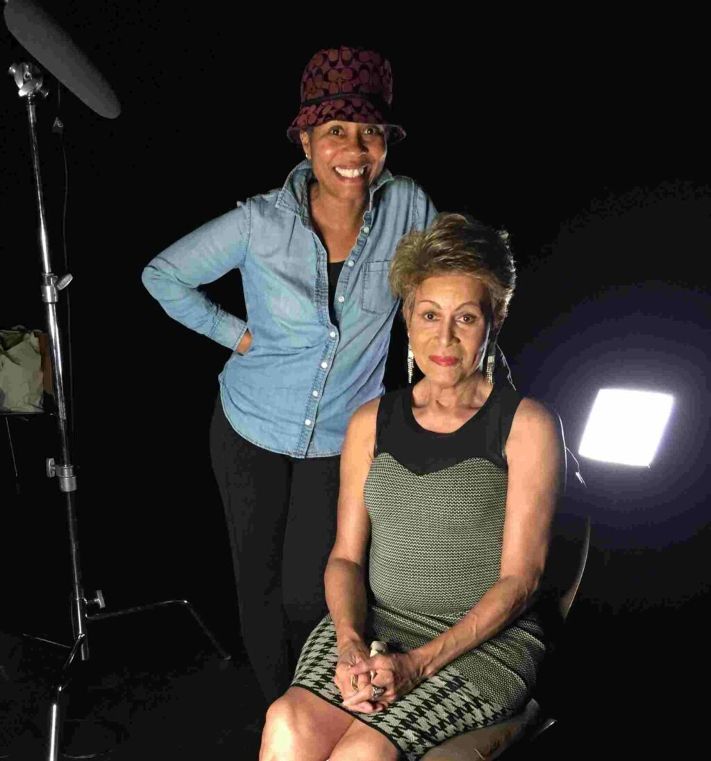 Mama Gloria (sitting) and Filmmaker Luchina Fisher.